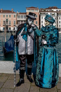 People in costume at the Venice carnival in front of the Madonna della Salute.