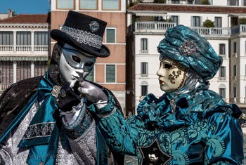 People in costume at the Venice carnival in front of the Madonna della Salute.