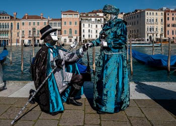 People in costume at the Venice carnival in front of the Madonna della Salute.