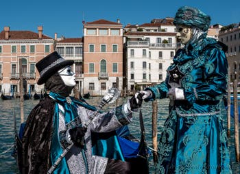 People in costume at the Venice carnival in front of the Madonna della Salute.