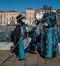 People in costume at the Venice carnival in front of the Madonna della Salute.