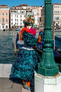 People in costume at the Venice carnival in front of the Madonna della Salute.