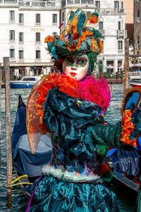 People in costume at the Venice carnival in front of the Madonna della Salute.