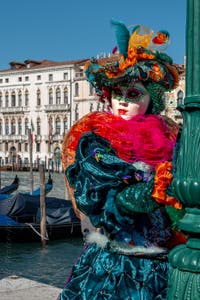 People in costume at the Venice carnival in front of the Madonna della Salute.