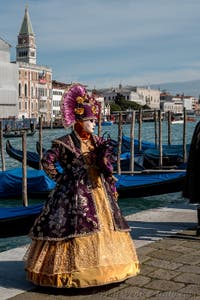 People in costume at the Venice carnival in front of the Madonna della Salute.