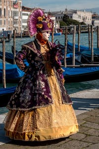 People in costume at the Venice carnival in front of the Madonna della Salute.