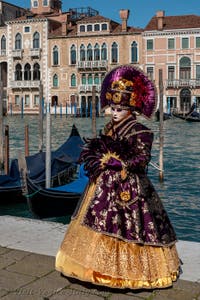 People in costume at the Venice carnival in front of the Madonna della Salute.