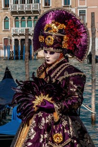 People in costume at the Venice carnival in front of the Madonna della Salute.