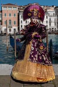 People in costume at the Venice carnival in front of the Madonna della Salute.