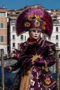 People in costume at the Venice carnival in front of the Madonna della Salute.