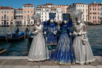 People in costume at the Venice carnival in front of the Madonna della Salute.