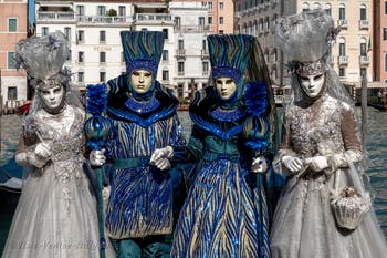 People in costume at the Venice carnival in front of the Madonna della Salute.