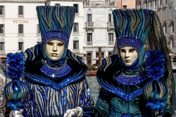 People in costume at the Venice carnival in front of the Madonna della Salute.