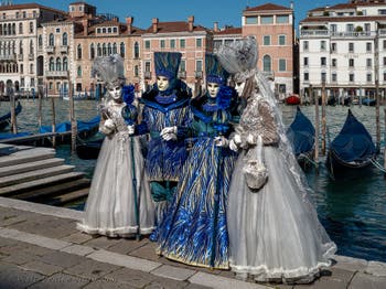 People in costume at the Venice carnival in front of the Madonna della Salute.