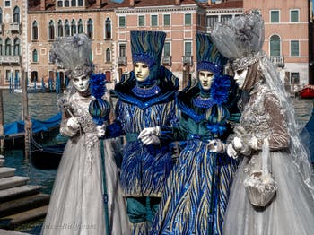 People in costume at the Venice carnival in front of the Madonna della Salute.