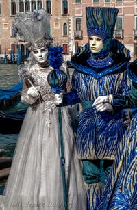 People in costume at the Venice carnival in front of the Madonna della Salute.