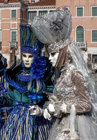 People in costume at the Venice carnival in front of the Madonna della Salute.