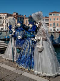 People in costume at the Venice carnival in front of the Madonna della Salute.