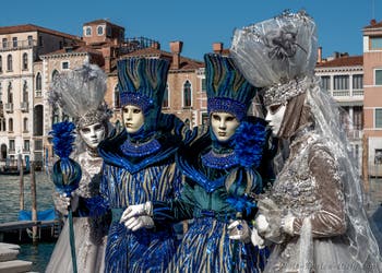 People in costume at the Venice carnival in front of the Madonna della Salute.