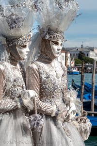 People in costume at the Venice carnival in front of the Madonna della Salute.