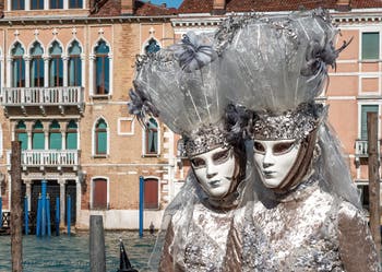 People in costume at the Venice carnival in front of the Madonna della Salute.