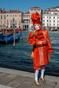 People in costume at the Venice carnival in front of the Madonna della Salute.