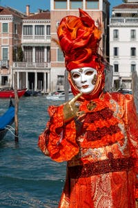 People in costume at the Venice carnival in front of the Madonna della Salute.