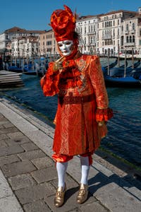 People in costume at the Venice carnival in front of the Madonna della Salute.