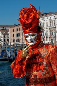 People in costume at the Venice carnival in front of the Madonna della Salute.