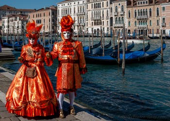 People in costume at the Venice carnival in front of the Madonna della Salute.