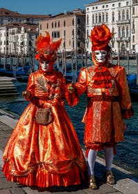 People in costume at the Venice carnival in front of the Madonna della Salute.