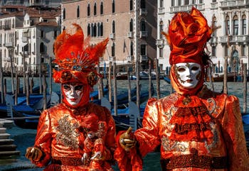 People in costume at the Venice carnival in front of the Madonna della Salute.