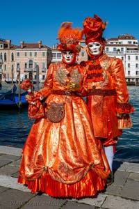 People in costume at the Venice carnival in front of the Madonna della Salute.