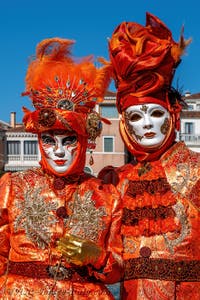 People in costume at the Venice carnival in front of the Madonna della Salute.