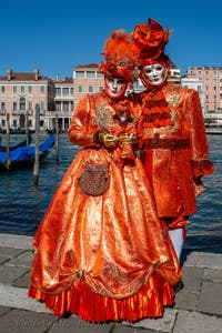 People in costume at the Venice carnival in front of the Madonna della Salute.