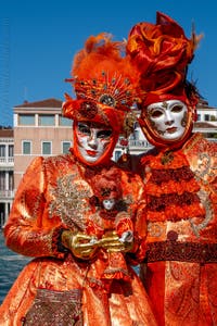 People in costume at the Venice carnival in front of the Madonna della Salute.