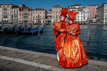 People in costume at the Venice carnival in front of the Madonna della Salute.