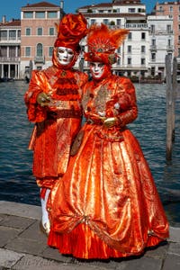 People in costume at the Venice carnival in front of the Madonna della Salute.