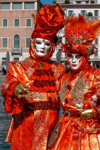 People in costume at the Venice carnival in front of the Madonna della Salute.