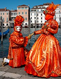 People in costume at the Venice carnival in front of the Madonna della Salute.