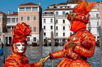 People in costume at the Venice carnival in front of the Madonna della Salute.