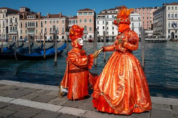 People in costume at the Venice carnival in front of the Madonna della Salute.