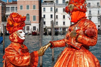 People in costume at the Venice carnival in front of the Madonna della Salute.