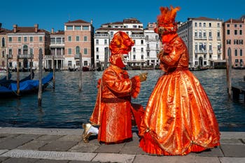 People in costume at the Venice carnival in front of the Madonna della Salute.