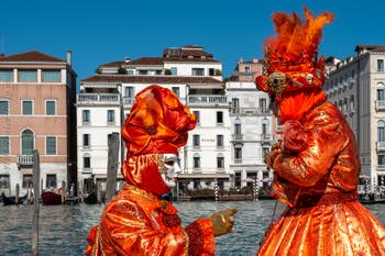 People in costume at the Venice carnival in front of the Madonna della Salute.