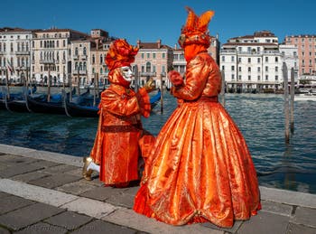 People in costume at the Venice carnival in front of the Madonna della Salute.