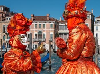 People in costume at the Venice carnival in front of the Madonna della Salute.