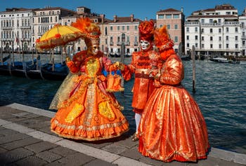 People in costume at the Venice carnival in front of the Madonna della Salute.