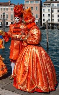 People in costume at the Venice carnival in front of the Madonna della Salute.