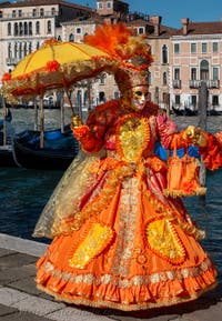 People in costume at the Venice carnival in front of the Madonna della Salute.